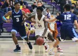 Lemoore High's Chris Taylor drives past two Redwood defenders in Thursday night's West Yosemite League opener in Lemoore. The Tigers beat the Rangers 69-55. 